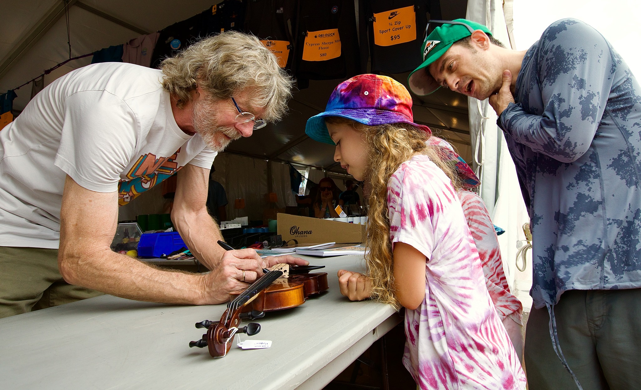 Sam Bush signing autographs for fans of all ages