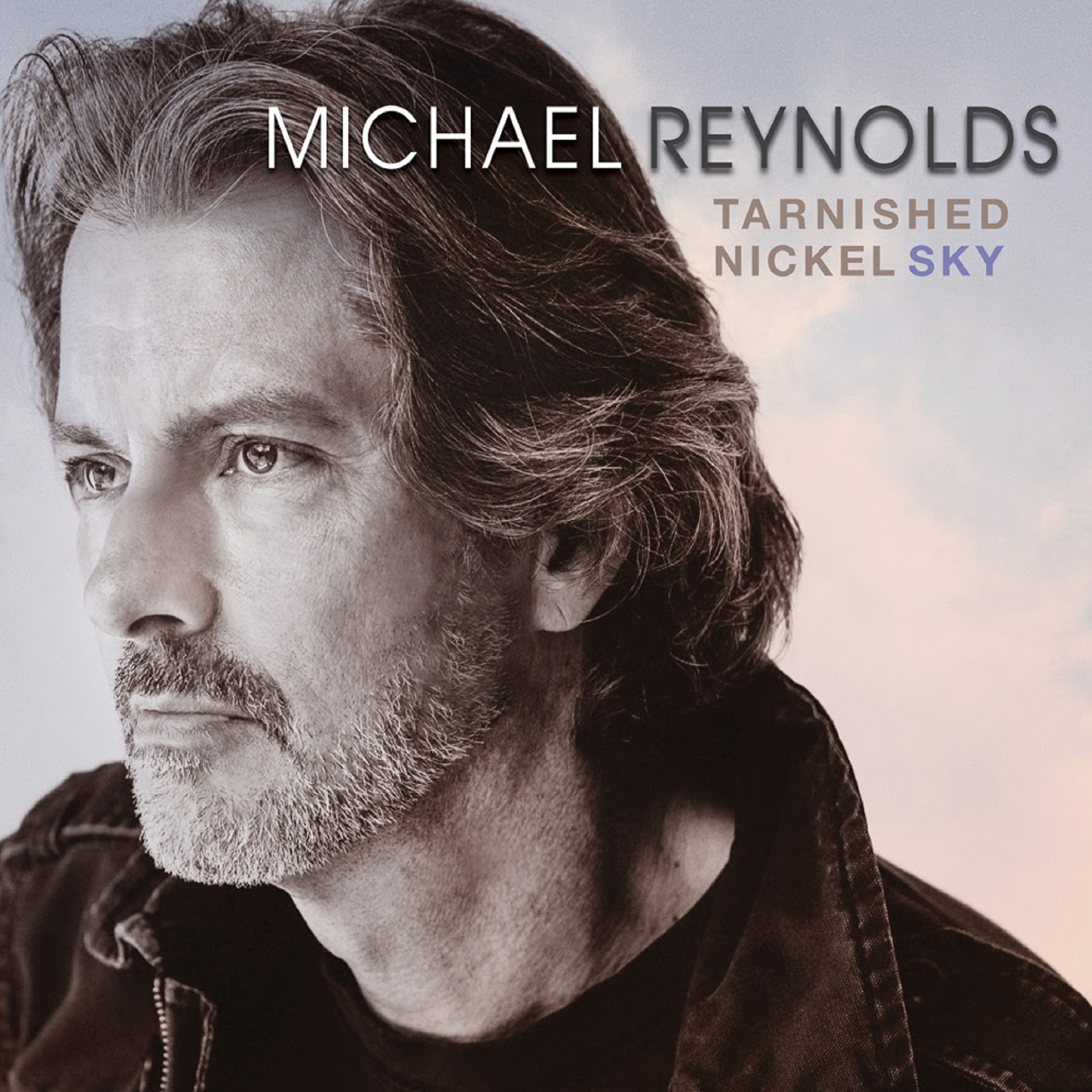 MICHAEL REYNOLDS RETURNS AFTER TEN YEARS WITH THE 'TARNISHED NICKEL SKY'