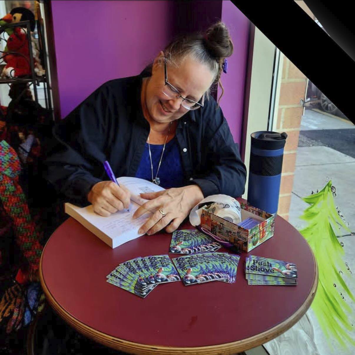 Hollie autographing copies of her book