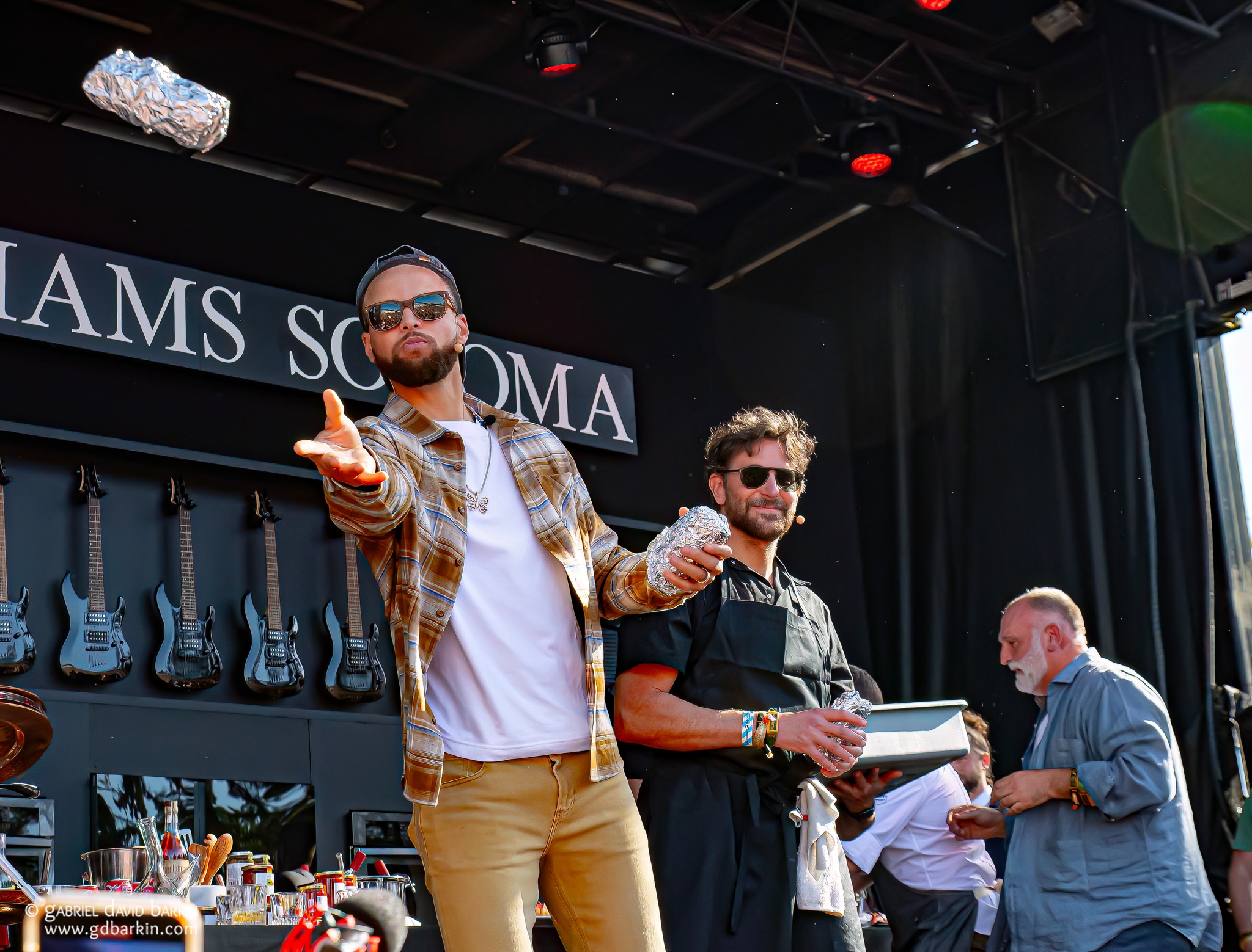 Steph Curry with Bradley Cooper throwing some Philly Cheesesteaks to the crowd