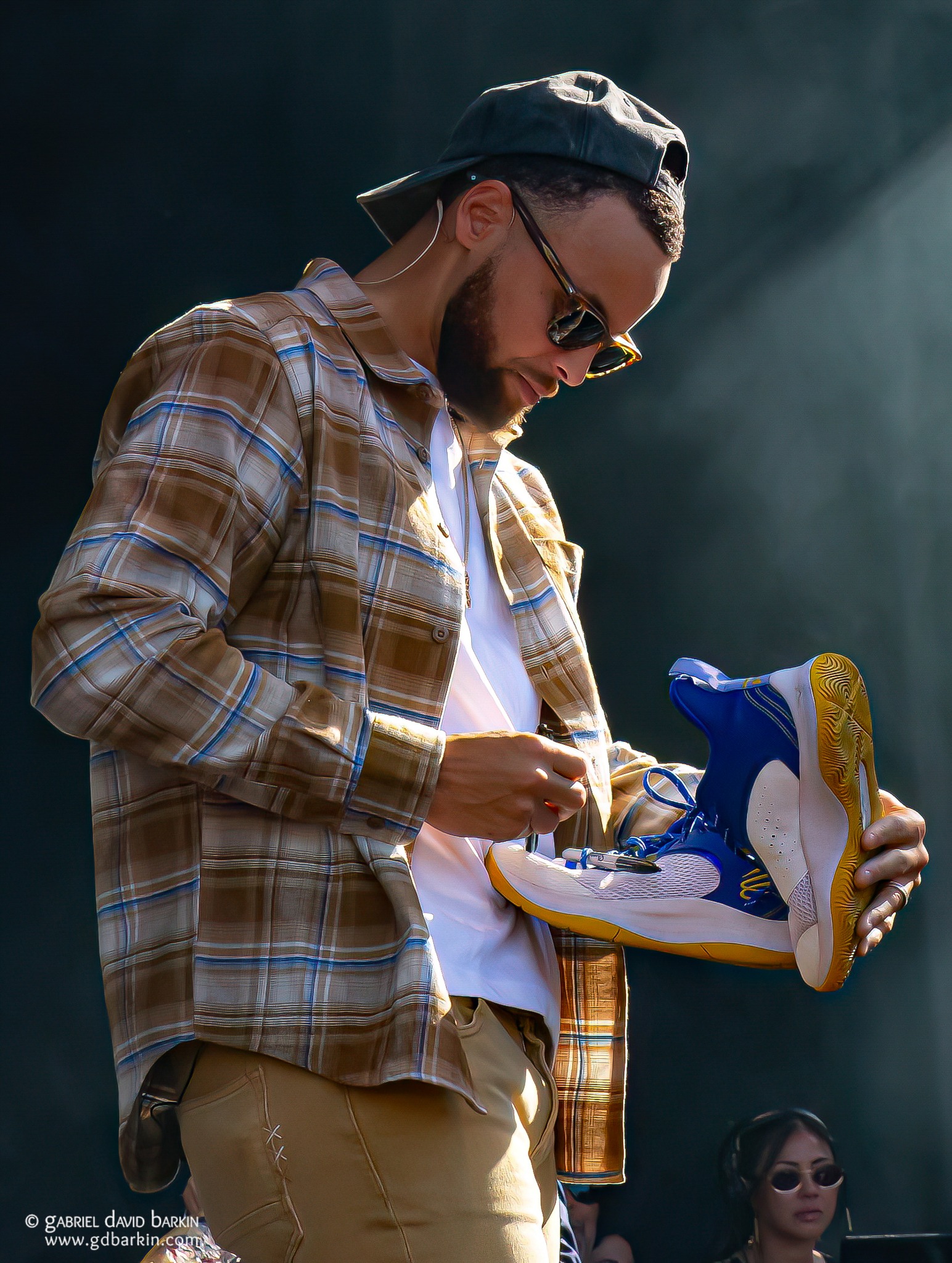 Steph Curry autographing some sneakers